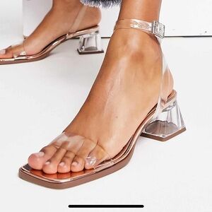 Clear sandals with block heel.